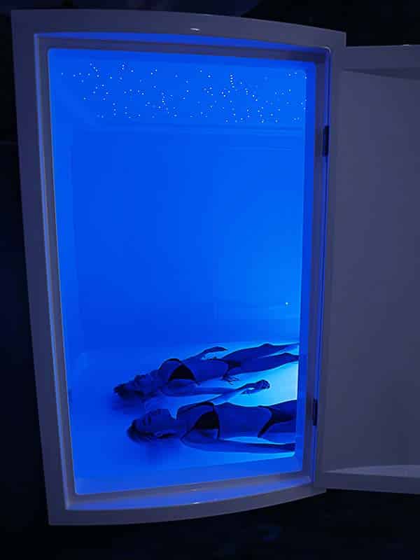 A couple floating together in a full-height float room